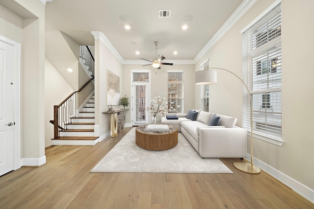 living room featuring ceiling fan, light hardwood / wood-style flooring, and ornamental molding