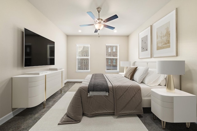 bedroom featuring ceiling fan and dark carpet