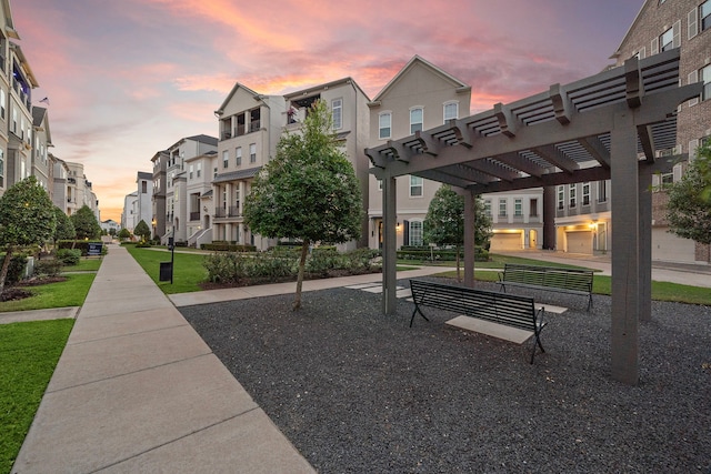 view of community with a pergola and a lawn