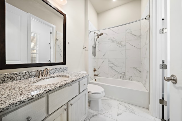 full bathroom with vanity, toilet, and tiled shower / bath