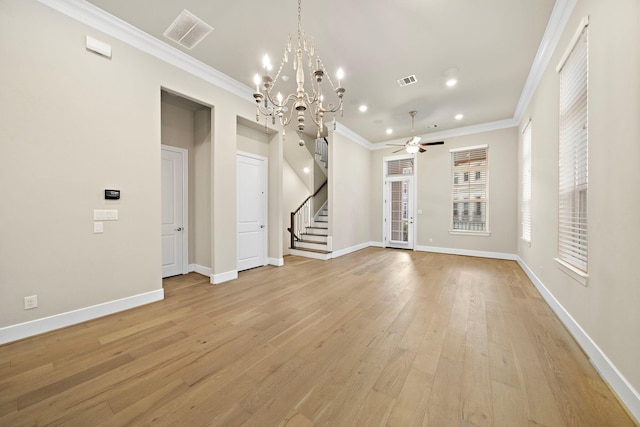 unfurnished living room featuring ceiling fan with notable chandelier, light wood-type flooring, and ornamental molding