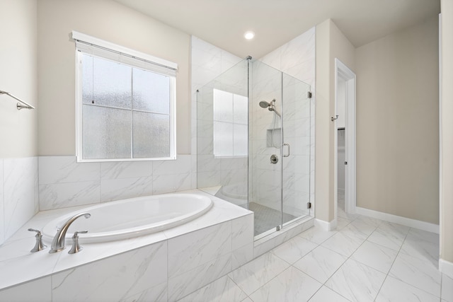 bathroom with separate shower and tub