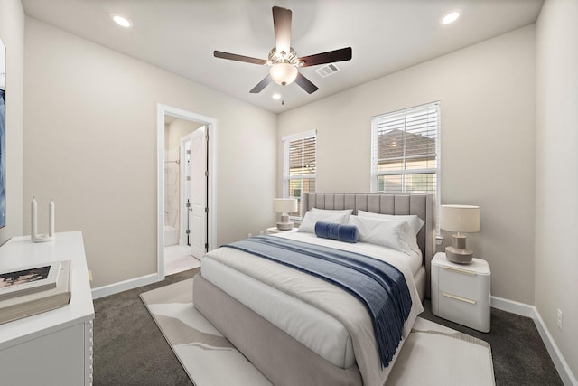 bedroom with ensuite bath, ceiling fan, and dark carpet