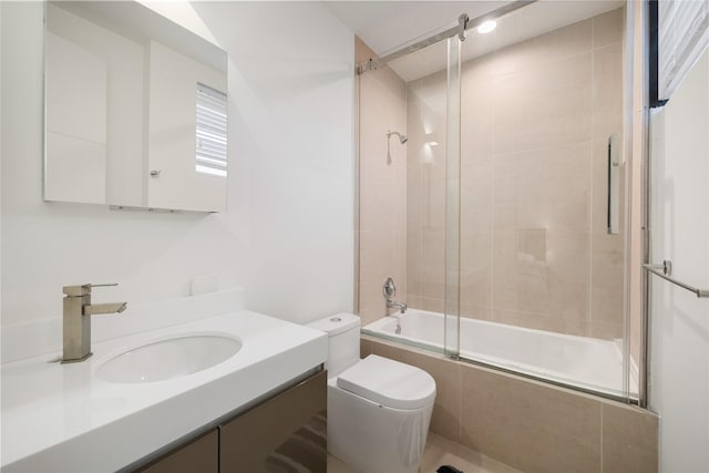 full bathroom with vanity, toilet, and bath / shower combo with glass door