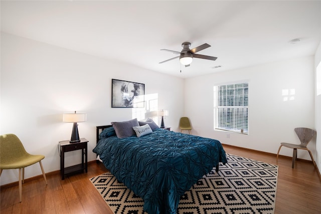 bedroom with wood-type flooring and ceiling fan