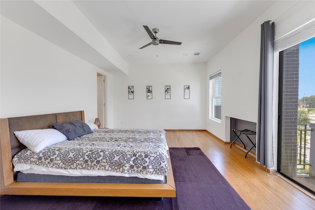 bedroom with hardwood / wood-style flooring, ceiling fan, and access to exterior