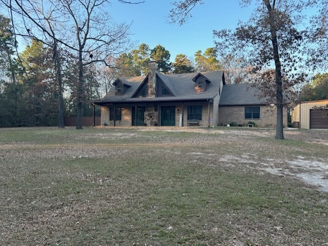 view of front of house with an outbuilding and a front yard