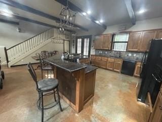 kitchen with a breakfast bar, a center island, black fridge, decorative backsplash, and beam ceiling