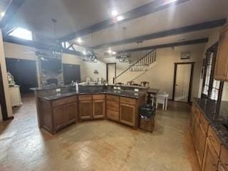 kitchen with kitchen peninsula and beamed ceiling