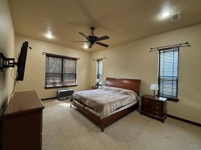 bedroom with ceiling fan and light colored carpet