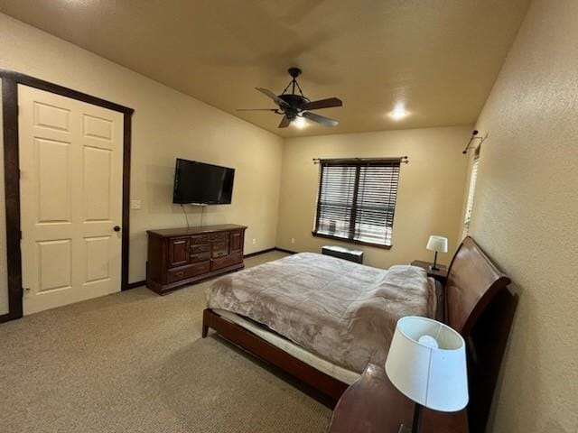 bedroom with ceiling fan and light colored carpet