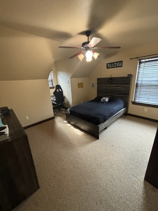 carpeted bedroom featuring ceiling fan and lofted ceiling