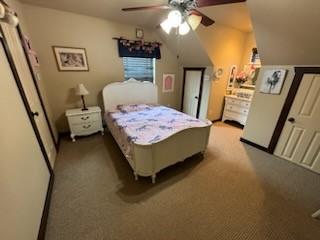 bedroom featuring ceiling fan, light colored carpet, and lofted ceiling