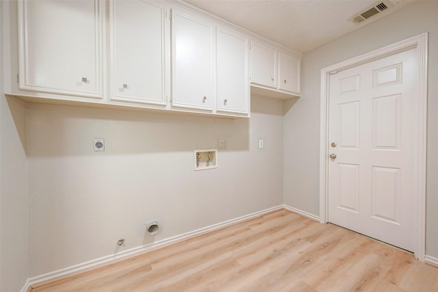 laundry room featuring cabinets, electric dryer hookup, hookup for a gas dryer, hookup for a washing machine, and light wood-type flooring