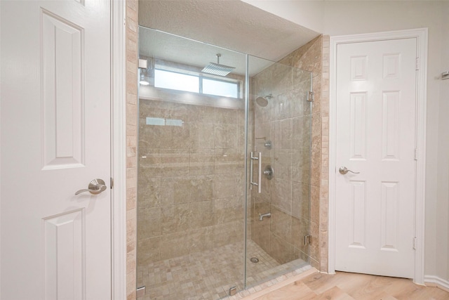 bathroom with a shower with door