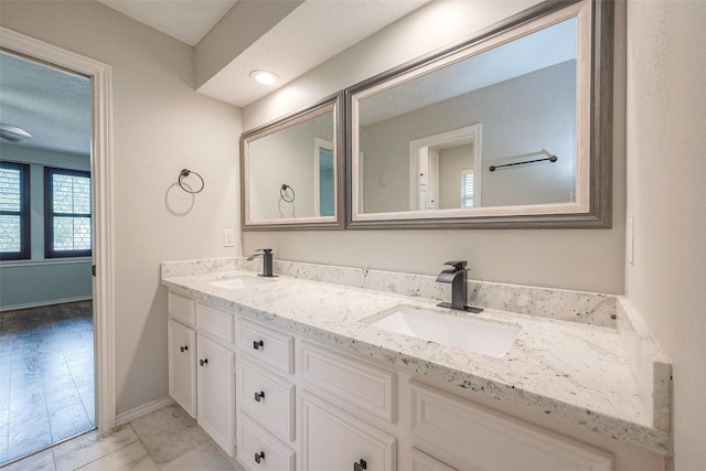 bathroom with a textured ceiling and vanity