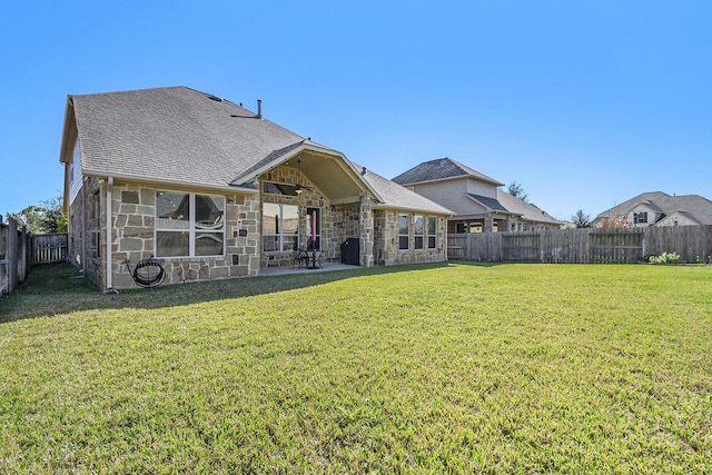 rear view of property featuring a patio area and a yard