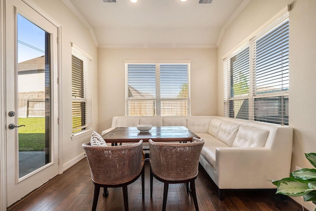 dining room with breakfast area, dark hardwood / wood-style floors, vaulted ceiling, and crown molding