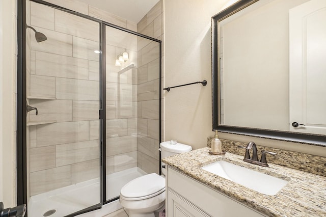 bathroom featuring vanity, toilet, and walk in shower