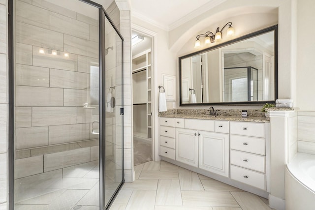 bathroom featuring crown molding, vanity, and shower with separate bathtub