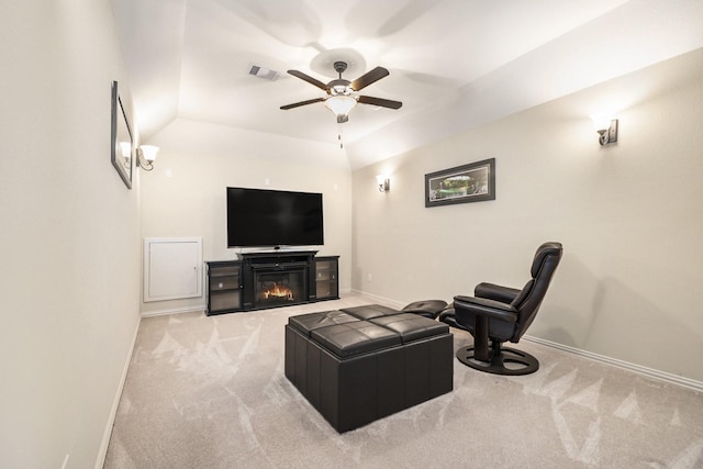 living room featuring ceiling fan, lofted ceiling, and light carpet