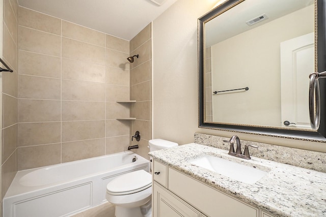 full bathroom with toilet, vanity, and tiled shower / bath