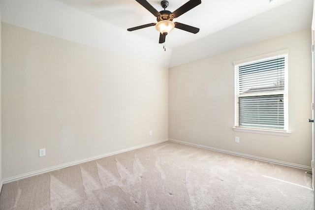 unfurnished room with light carpet, ceiling fan, and vaulted ceiling