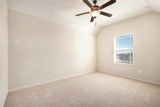 carpeted empty room with vaulted ceiling and ceiling fan