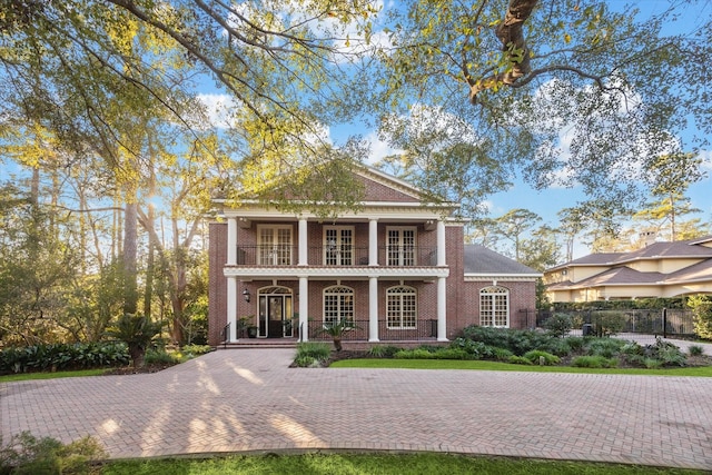 neoclassical / greek revival house with a balcony and covered porch