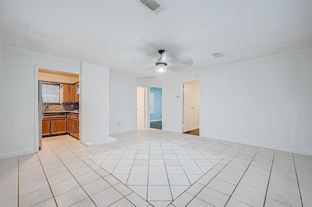 tiled empty room with ceiling fan