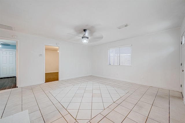 empty room featuring ceiling fan and light tile patterned floors