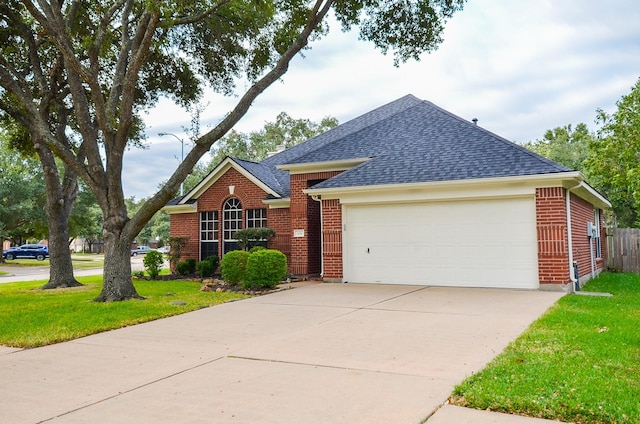 view of front facade with a front yard and a garage