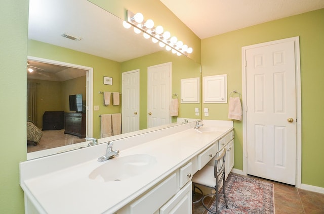 bathroom with tile patterned floors, vanity, and ceiling fan