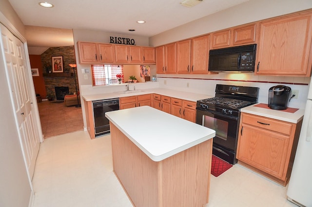 kitchen with black appliances, a kitchen island, sink, and a fireplace