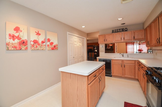 kitchen featuring dishwasher, gas stove, a kitchen island, and sink