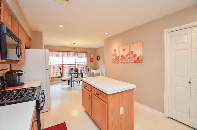 kitchen featuring a center island, decorative light fixtures, and white gas range oven