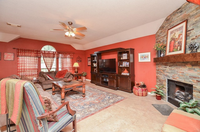 living room with ceiling fan, a fireplace, and vaulted ceiling