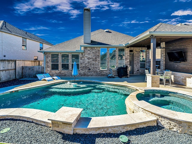 view of pool with an in ground hot tub, a patio, and ceiling fan