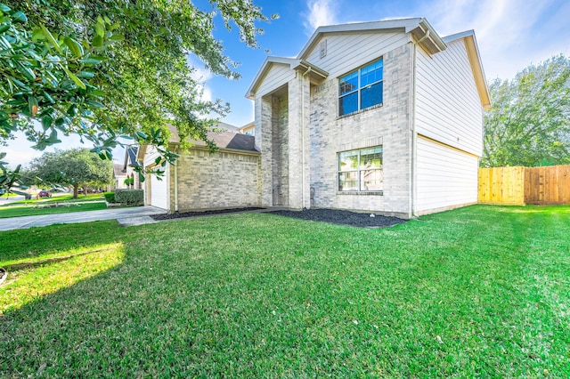 view of side of home featuring a yard and a garage