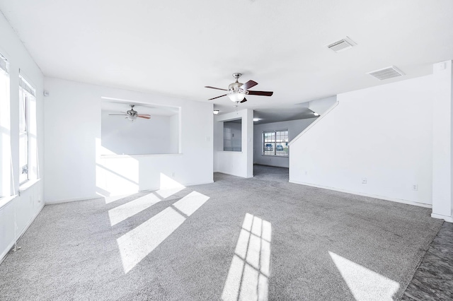 unfurnished living room with ceiling fan and light carpet