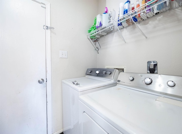 laundry area with washing machine and clothes dryer