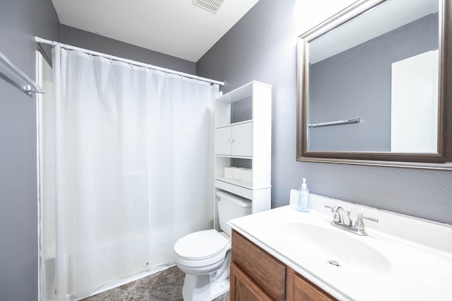 bathroom featuring walk in shower, vanity, and toilet