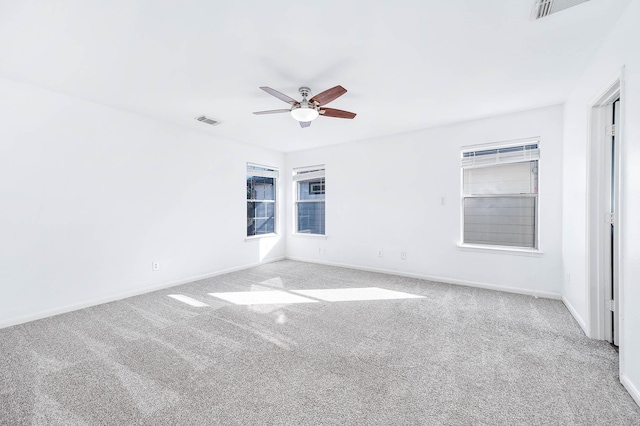 unfurnished room with ceiling fan and light colored carpet