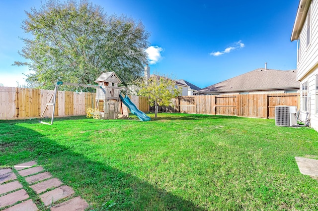 view of yard featuring a playground and central AC