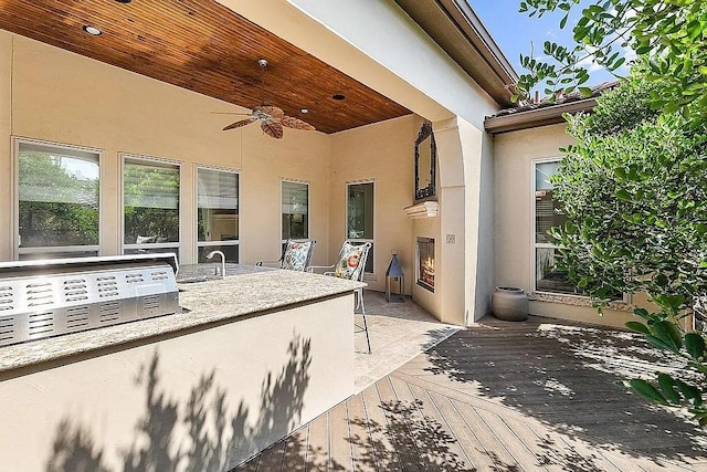 view of patio / terrace with ceiling fan and a deck