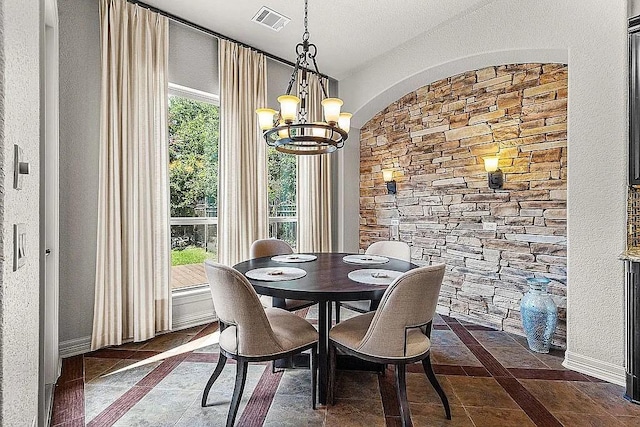 dining space with a notable chandelier