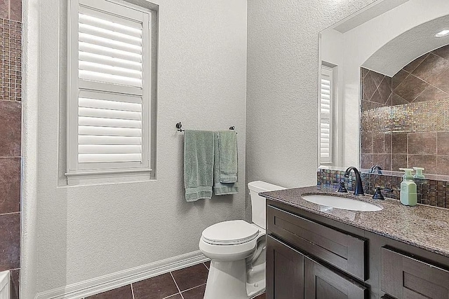 bathroom featuring tile patterned floors, vanity, and toilet