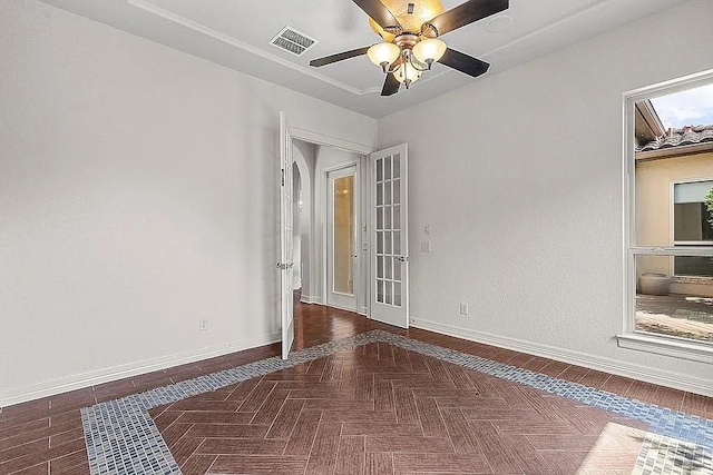 empty room featuring ceiling fan and dark parquet floors