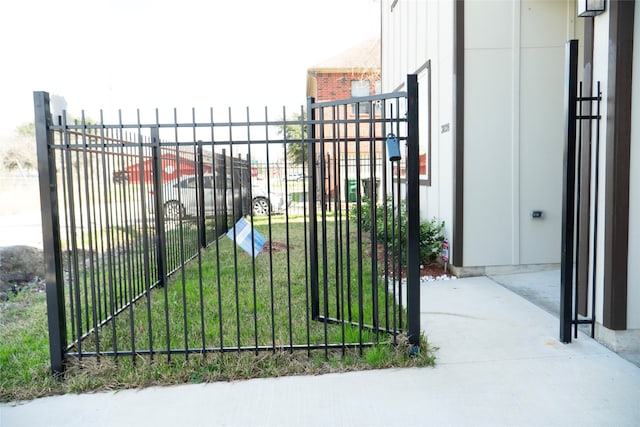 view of gate featuring a yard