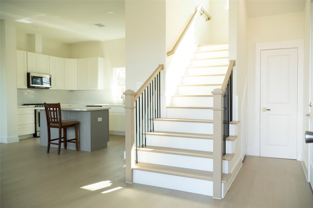 stairs with hardwood / wood-style floors